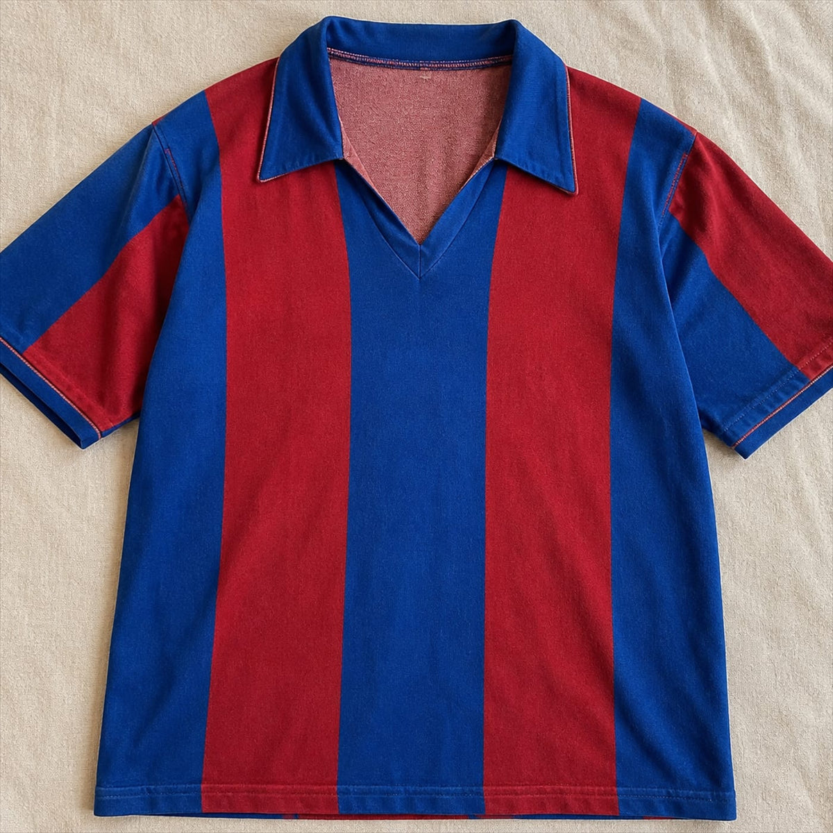 A single vintage football shirt folded on a table