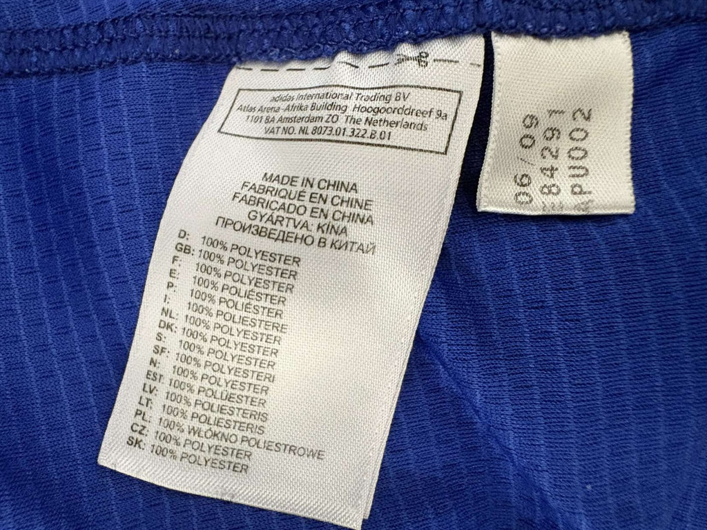 Inner adidas care label showing product code 84291 and 06/09 production date