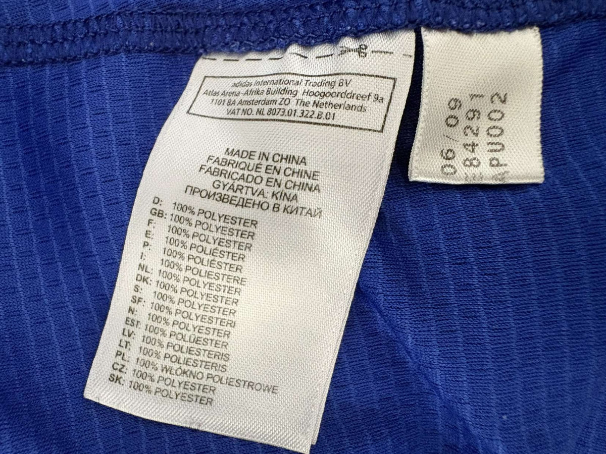 Inner adidas care label showing product code 84291 and 06/09 production date