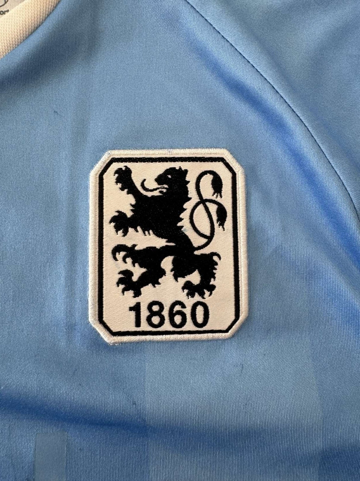 TSV 1860 Munich club crest on the 2013/14 home shirt