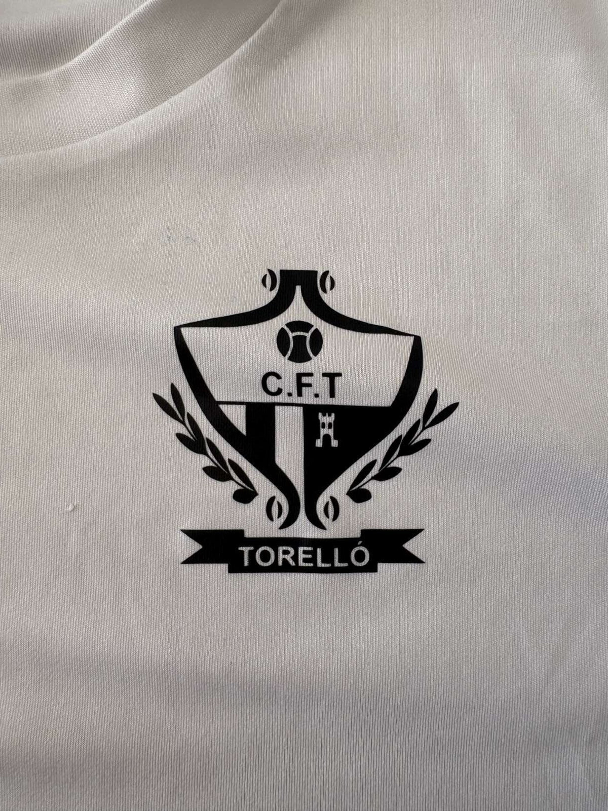 FC Torelló club crest on the 2021/22 home shirt
