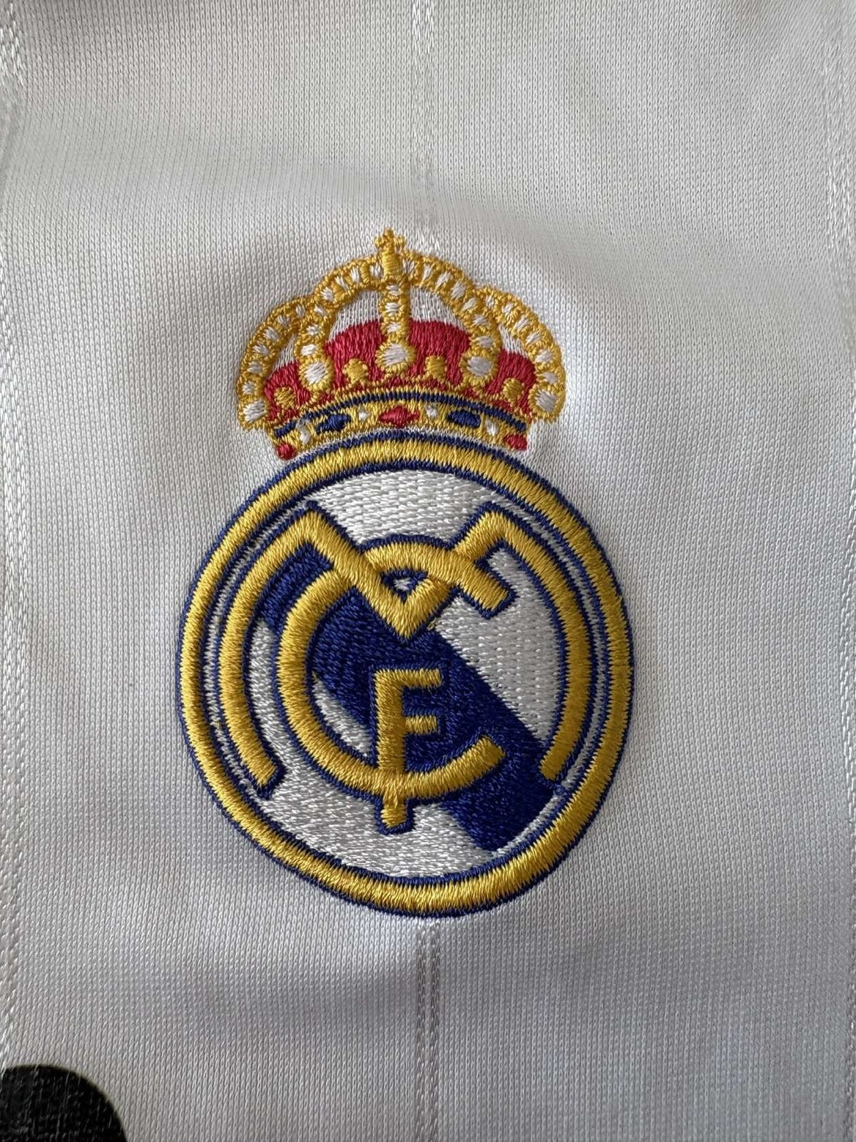 Real Madrid club crest on the 2012/13 home shirt