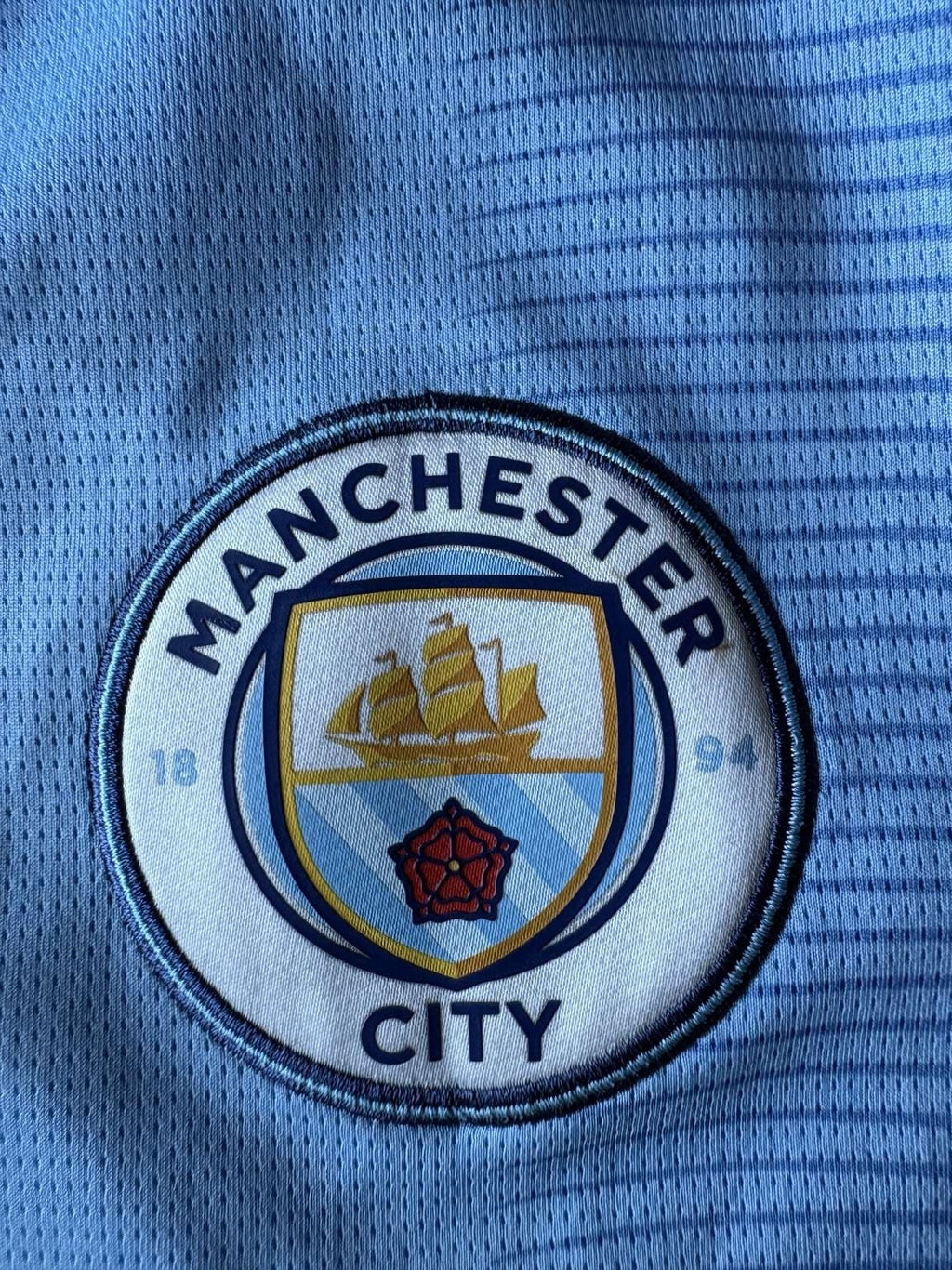 Manchester City crest on the 2023/24 Manchester City home shirt