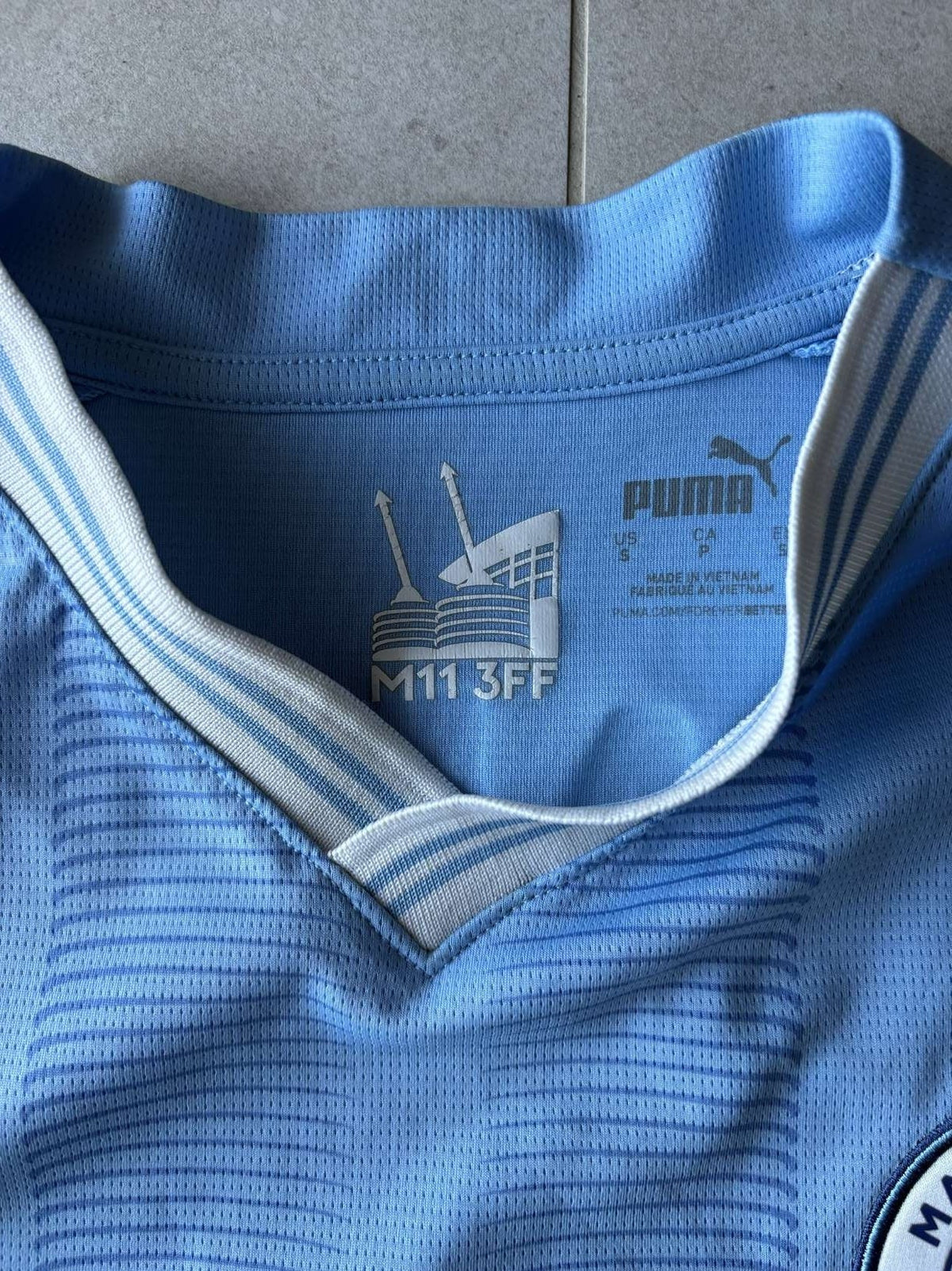 Neck detail on the 2023/24 Manchester City home shirt