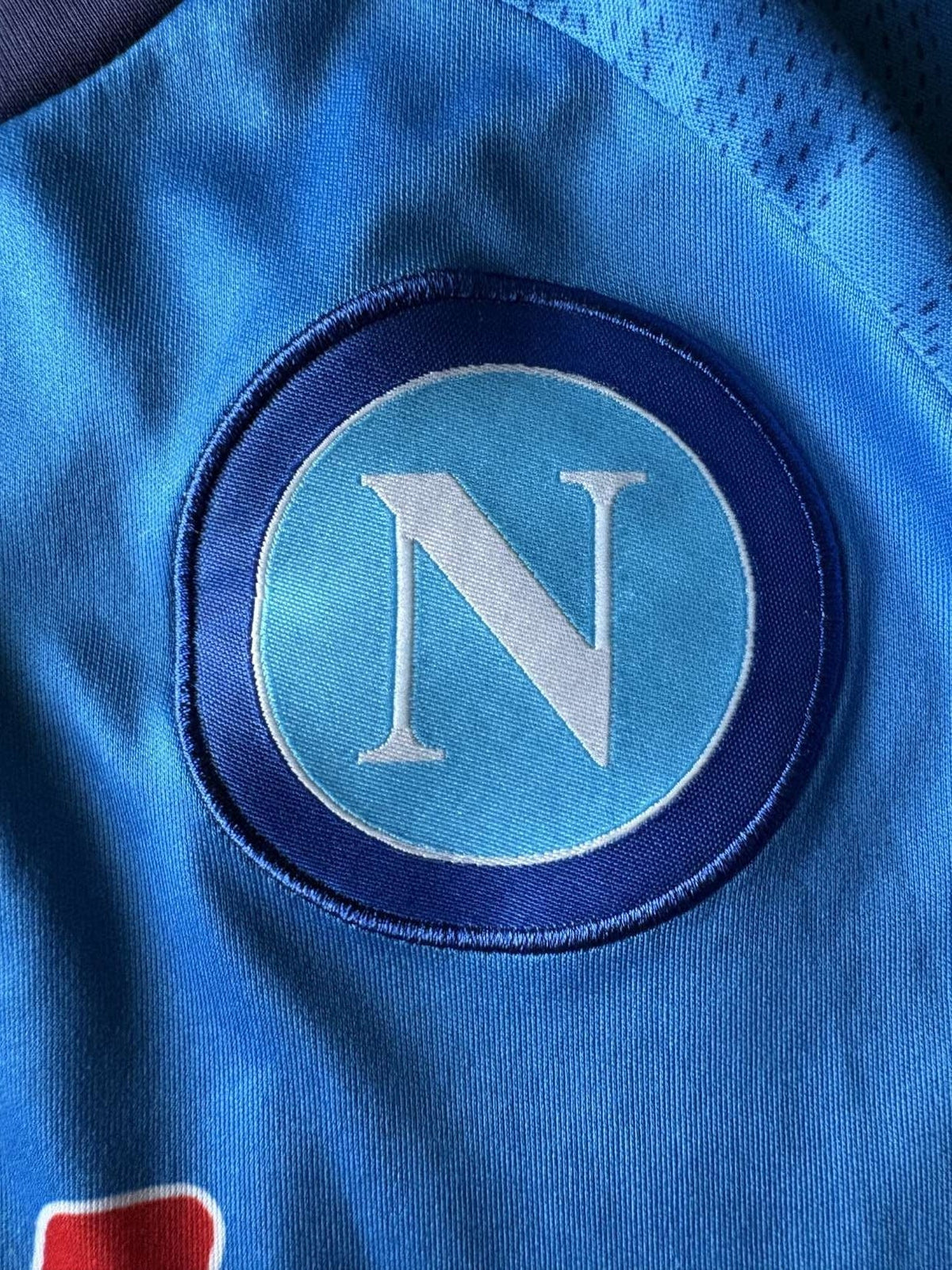 Napoli crest on the 2020/21 Napoli home shirt