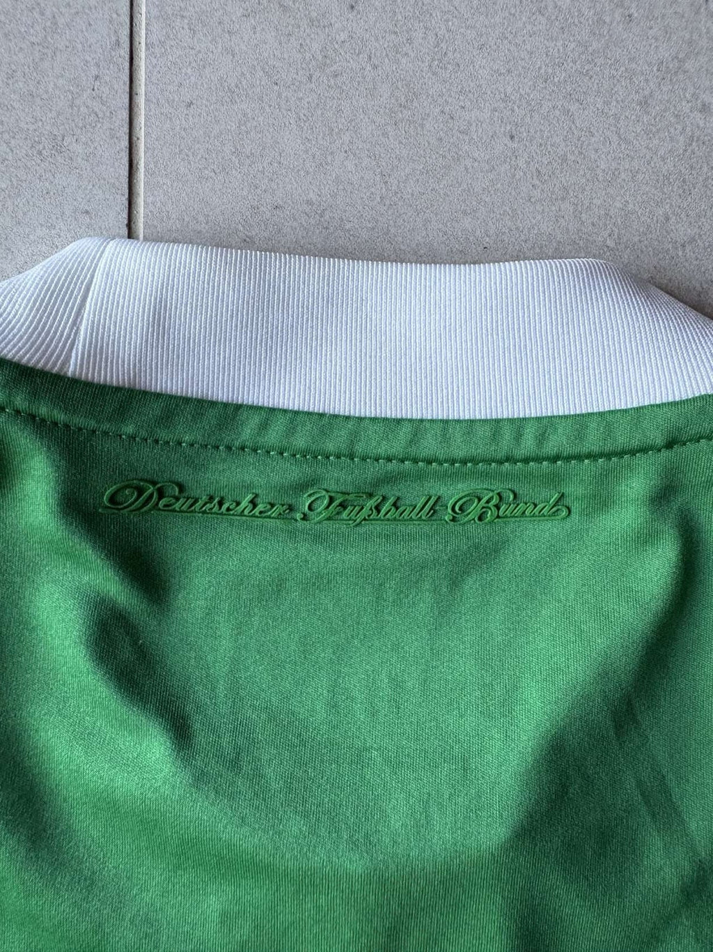 Deutscher Fussball-Bund lettering below the collar of the 2012 Germany away shirt
