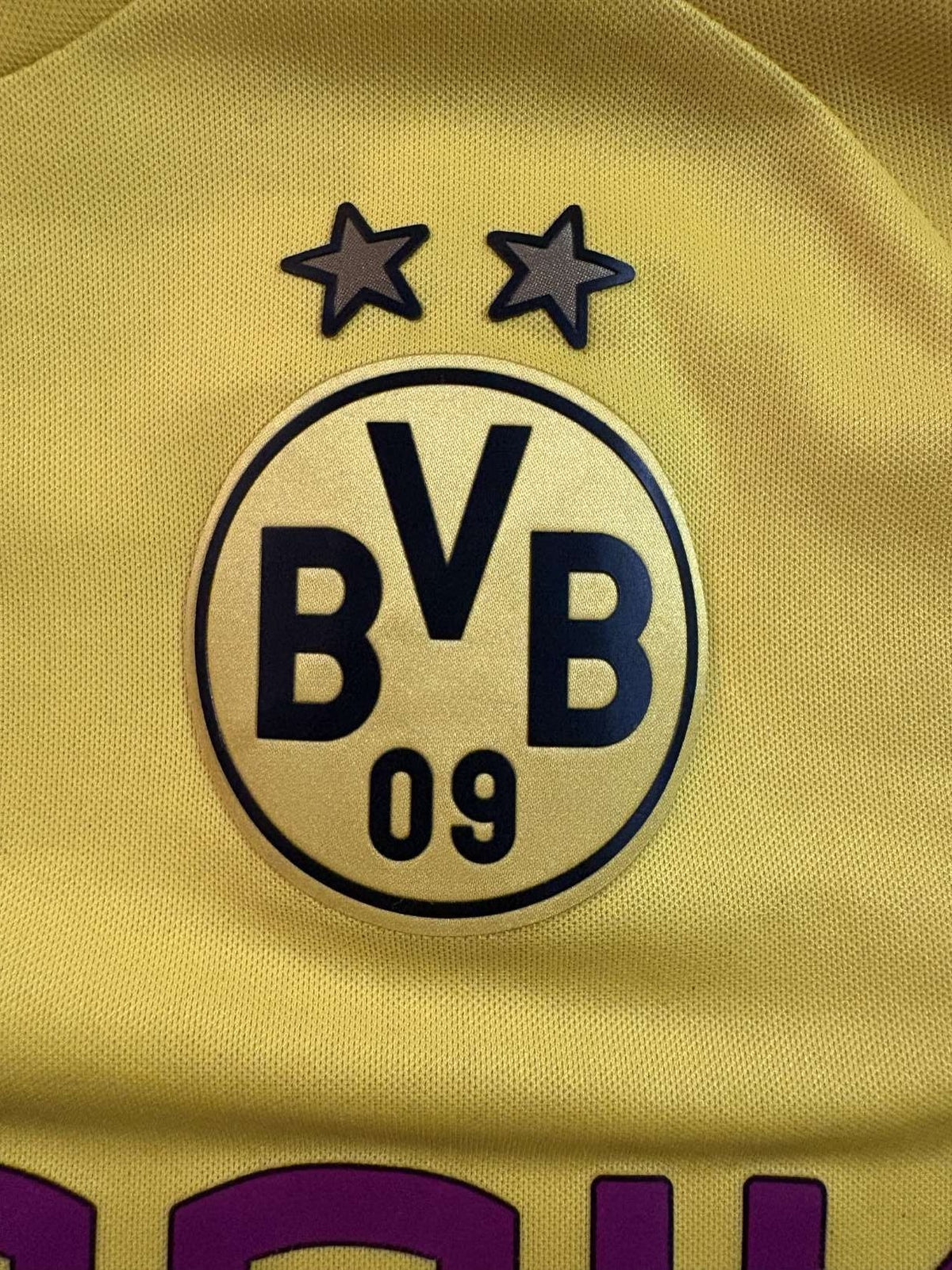 Borussia Dortmund club crest on the 2014/15 home shirt