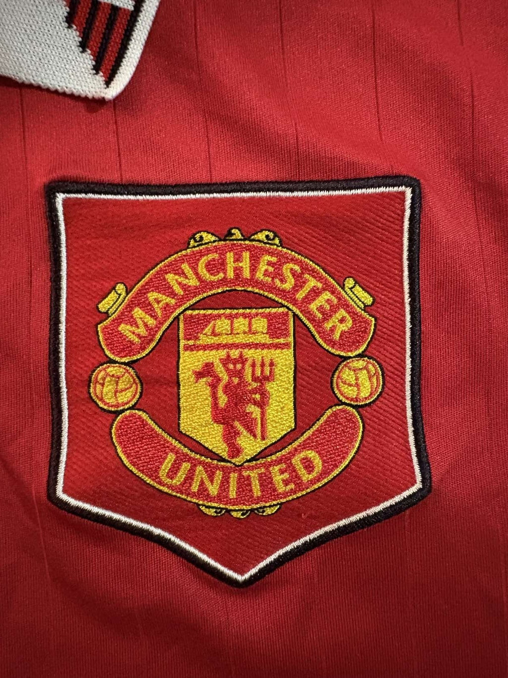 Manchester United club crest on the 2022/23 home shirt