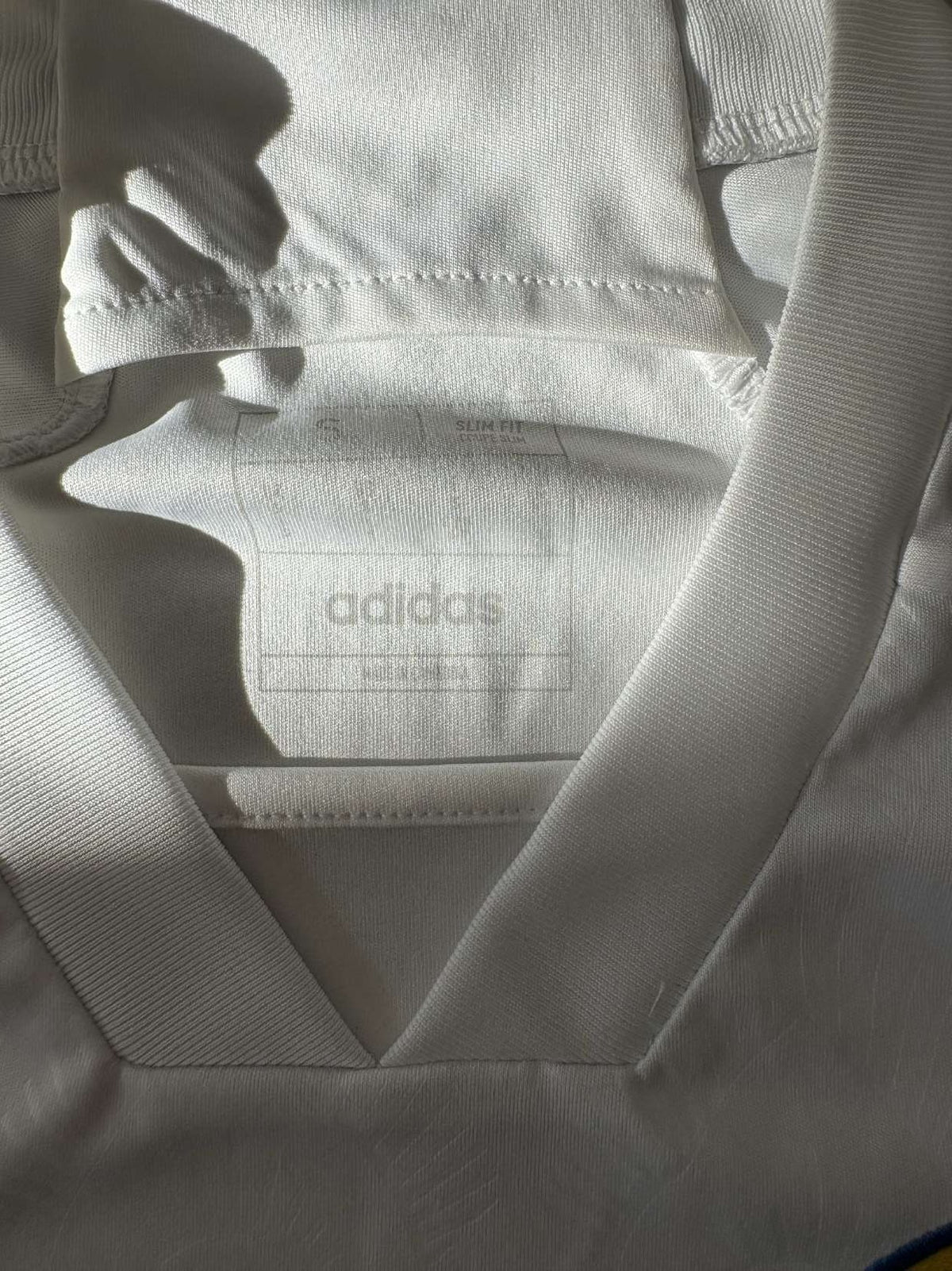 Neck and collar detail on the 2023/24 Leeds United home shirt