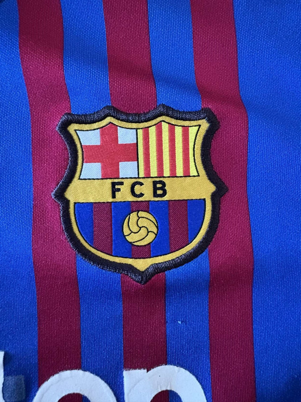 Barcelona club crest on the 2021/22 home shirt