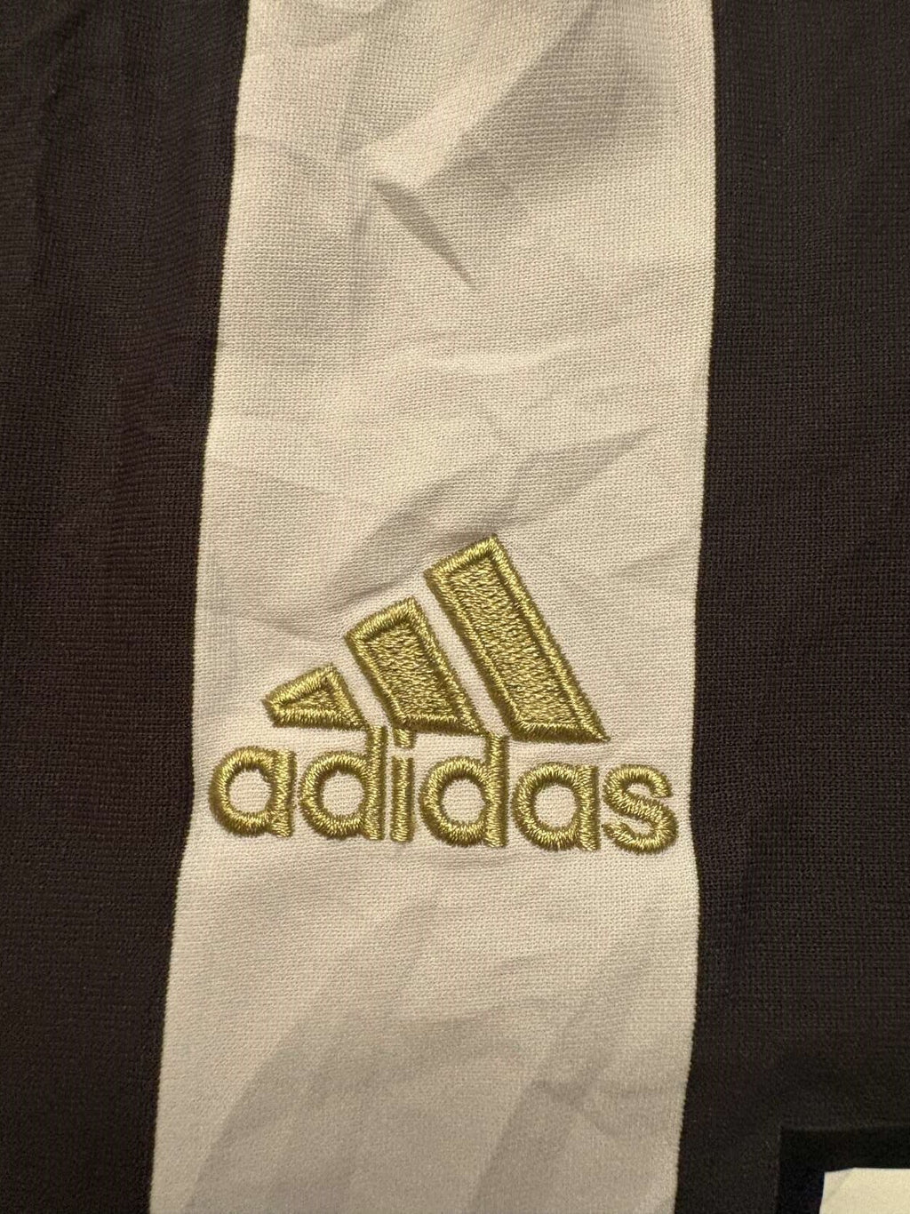 Gold adidas branding on the 2017/18 Juventus home shirt