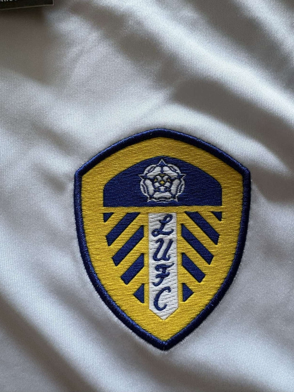 Leeds United club crest on the 2014/15 home shirt