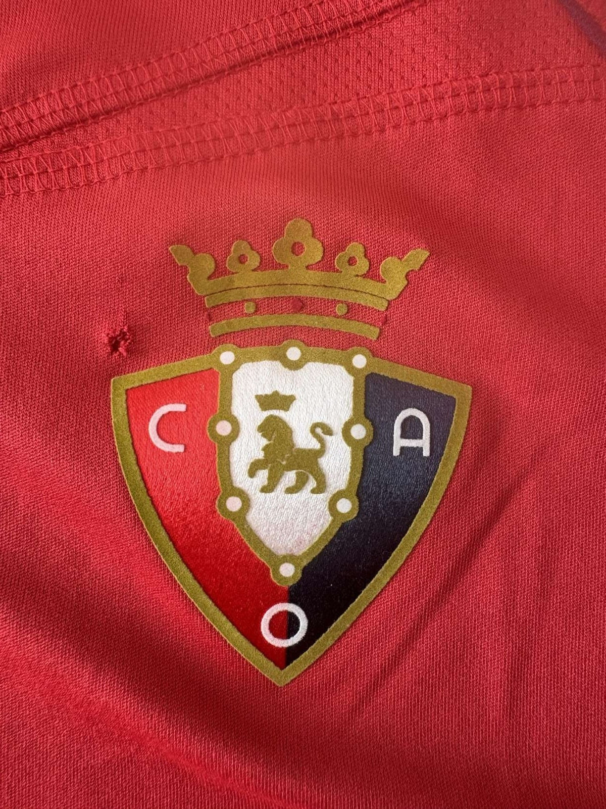 Osasuna club crest on the home shirt