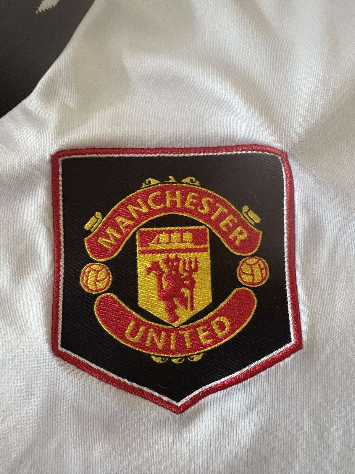 Manchester United crest on the 2022/23 away shirt