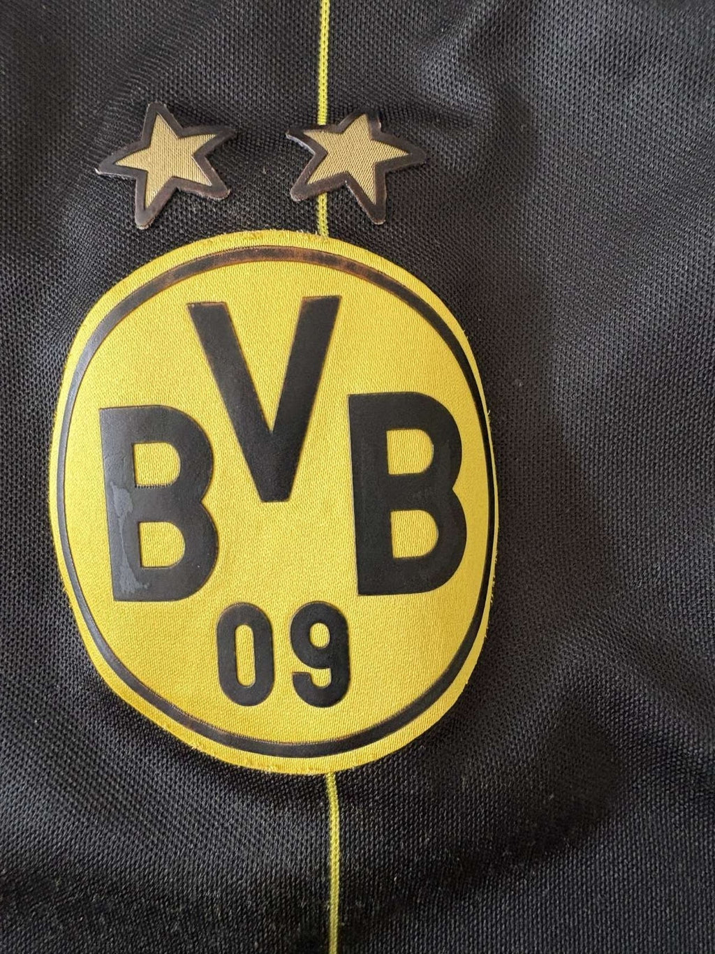 Borussia Dortmund crest on the 2014/15 away shirt