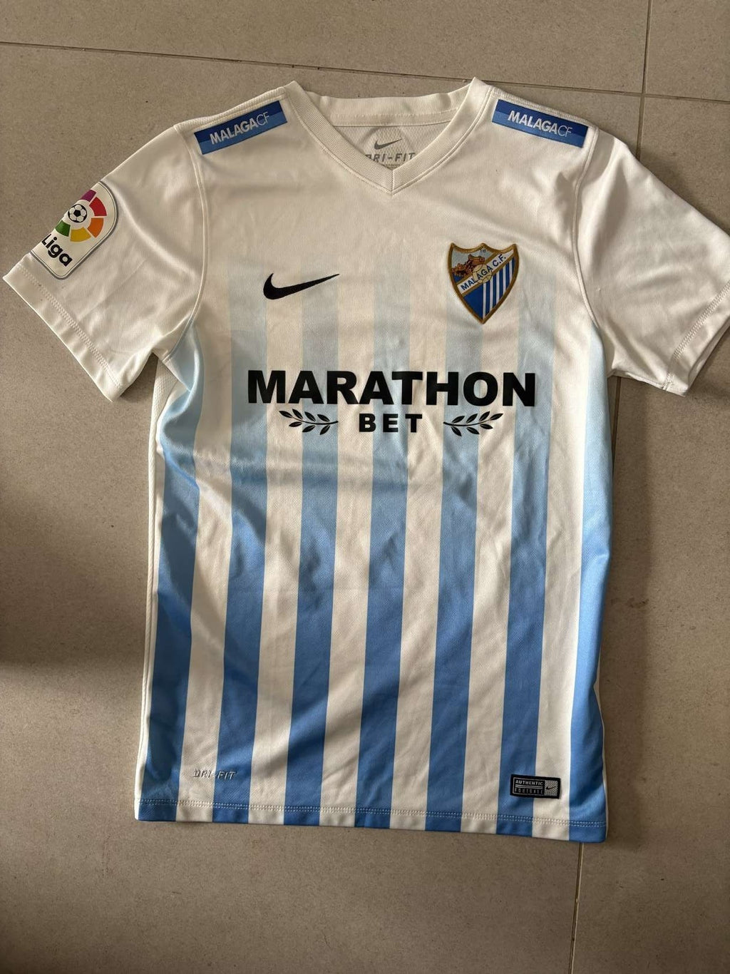 Malaga home shirt, front, Nike with MarathonBet sponsor